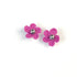 Pair of magenta crochet flower earrings on a white background