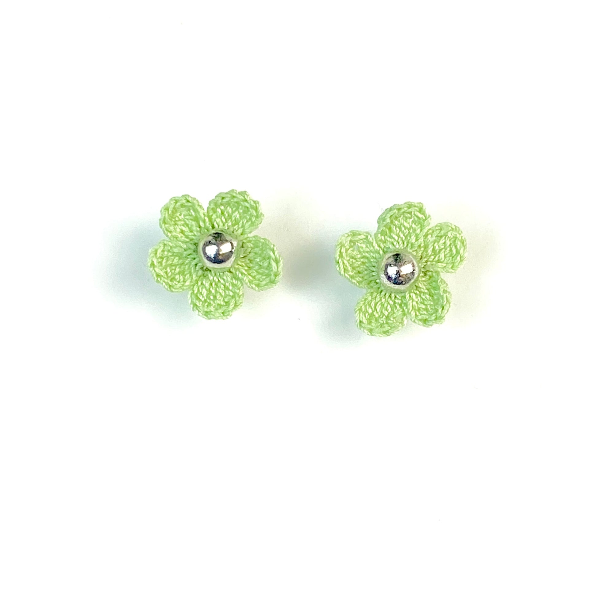 Pair of green crochet flower earrings on a white background
