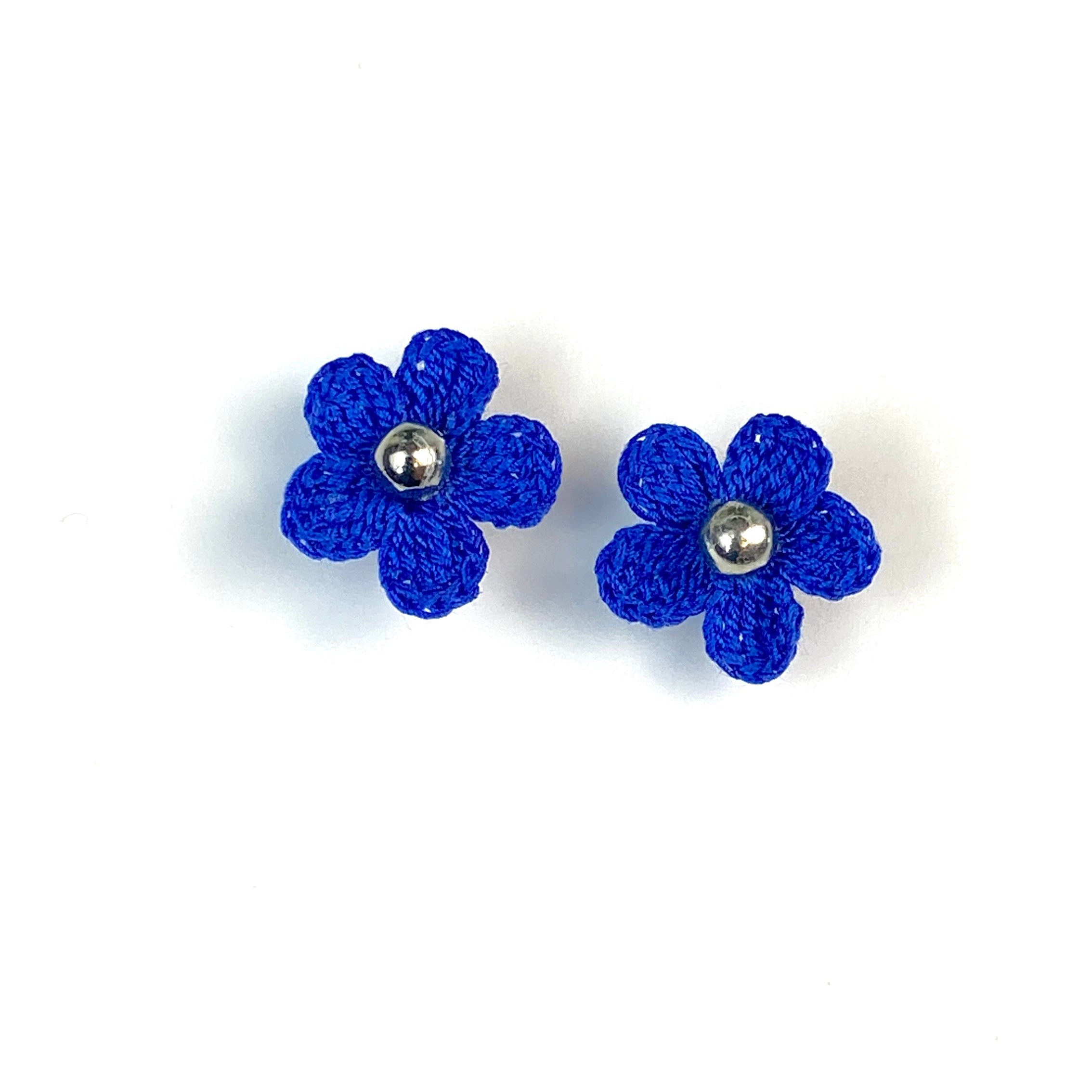 Pair of blue crochet flower earrings on a white background