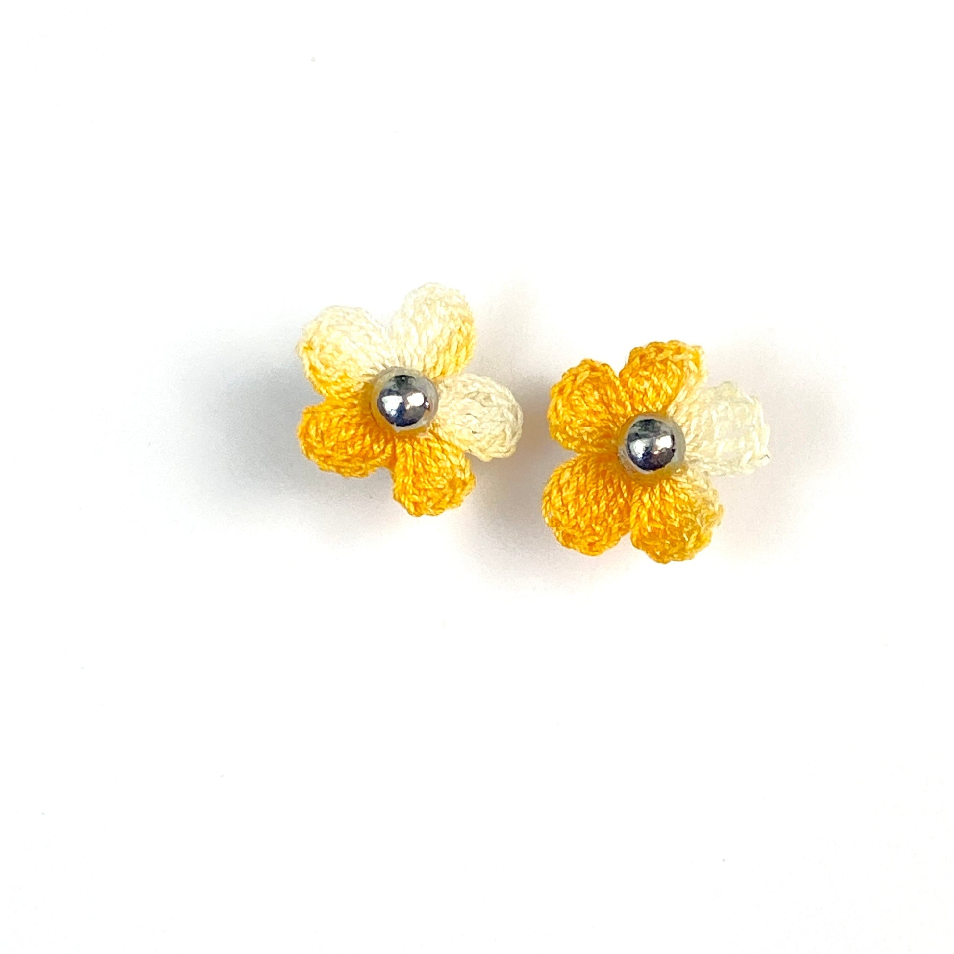 Pair of yellow crochet flower earrings on a white background