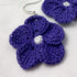 Purple crocheted flower earrings on a light background