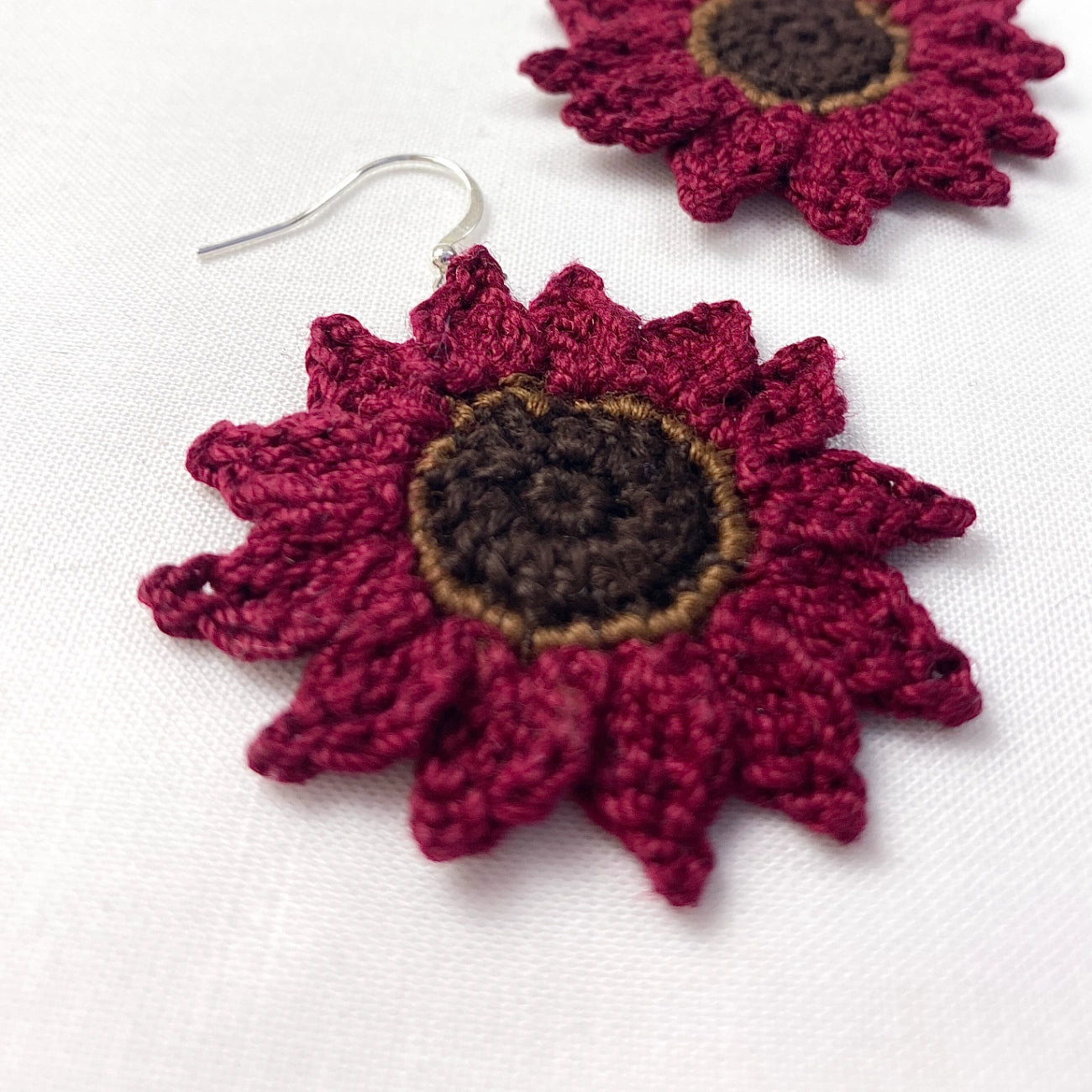 Crocheted flower earrings on a white background